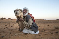 Man with his camel in a desert in Sudan Stock Photo Man with his camel in a desert in Sudan Stock Photo