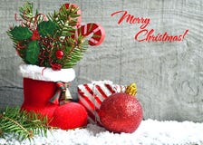 Merry Christmas greeting card.Xmas card.Red Santa`s boot with fir tree branch,decorative holly berry leaves,candy cane and red Chr Royalty Free Stock Photos Merry Christmas greeting card.Xmas card.Red Santa`s boot with fir tree branch,decorative holly berry leaves,candy cane and red Chr Royalty Free Stock Photos