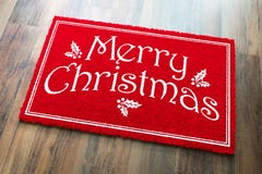 Merry Christmas Red Welcome Mat On Wood Floor Background stock image Merry Christmas Red Welcome Mat On Wood Floor Background stock image