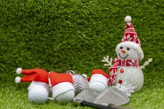 Merry Christmas to golfer with golf ball are on green grass with Christmas ornament