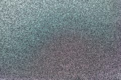 Metallisk virkad tygtextur, med liten purpurfärgad och grön färg royaltyfri fotografi Metallisk virkad tygtextur, med liten purpurfärgad och grön färg royaltyfri fotografi