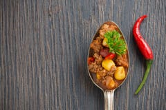 Mexican Dish Chili Con Carne In A Spoon On A Wooden Background Stock Photos