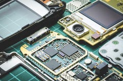 Microchips, semiconductor components and precious metals on the Board of the disassembled old mobile phone close-up royalty free stock images Microchips, semiconductor components and precious metals on the Board of the disassembled old mobile phone close-up royalty free stock images