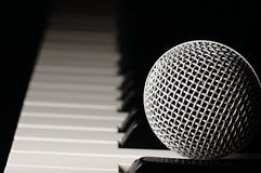 Microphone on a piano keyboard. stock image Microphone on a piano keyboard. stock image
