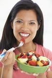Mid Adult Woman Eating Fresh Fruit Salad royalty free stock photo Mid Adult Woman Eating Fresh Fruit Salad royalty free stock photo