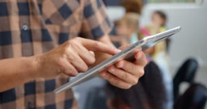 Mid section of male teacher using digital tablet in the classroom 4k stock video Mid section of male teacher using digital tablet in the classroom 4k stock video