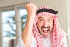 Handsome arabian senior man at home stock photo Handsome arabian senior man at home stock photo