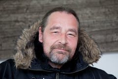 Middle Age Man in Hooded Coat Looking at Camera royalty free stock photography Middle Age Man in Hooded Coat Looking at Camera royalty free stock photography