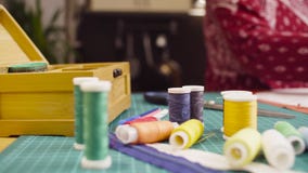Middle-age woman hands pinning a paper pattern to the fabric with pins royalty free stock photo Middle-age woman hands pinning a paper pattern to the fabric with pins royalty free stock photo