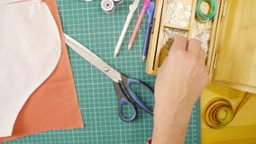 Middle-age woman hands pinning a paper pattern to the fabric with pins stock image Middle-age woman hands pinning a paper pattern to the fabric with pins stock image