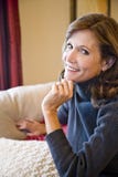Middle-aged woman relaxing on living room sofa royalty free stock photography Middle-aged woman relaxing on living room sofa royalty free stock photography