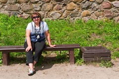 Middle-aged Woman Relaxing On A Bench Stock Image Middle-aged Woman Relaxing On A Bench Stock Image
