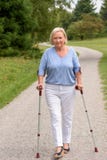 Middle Aged Woman Walking with Two Canes stock images Middle Aged Woman Walking with Two Canes stock images