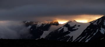 Midnight Sun Over The Snowy Mountains Stock Photography