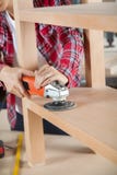 Midsection Of Carpenter Using Sander On Shelf royalty free stock images Midsection Of Carpenter Using Sander On Shelf royalty free stock images