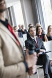 Midsection of public speaker with business people in seminar hall royalty free stock image Midsection of public speaker with business people in seminar hall royalty free stock image