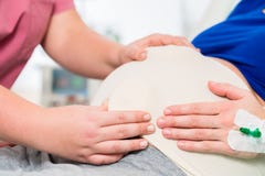 Midwife or nurse feeling baby belly of pregnant woman stock photography Midwife or nurse feeling baby belly of pregnant woman stock photography