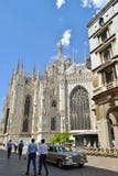 Duomo of Milan and a moving old Mercedes-Benz car. royalty free stock photography Duomo of Milan and a moving old Mercedes-Benz car. royalty free stock photography