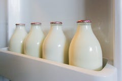 Milk Bottles In Fridge Door Royalty Free Stock Photo