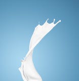 Milk or white liquid splash on blue background stock photo Milk or white liquid splash on blue background stock photo