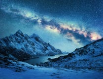 Milky Way over snow covered mountains and sea coast at night stock images Milky Way over snow covered mountains and sea coast at night stock images