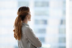 Millennial businesswoman looking in window dreaming of career pr royalty free stock photography Millennial businesswoman looking in window dreaming of career pr royalty free stock photography