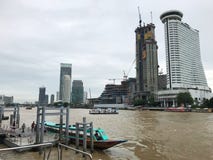 Millénaire Hilton construisant près de construire ceux sur un autre pilier de rivière Images stock Millénaire Hilton construisant près de construire ceux sur un autre pilier de rivière Images stock