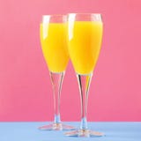 Mimosa Alcohol Cocktail With Orange Juice And Dry Champagne Or Sparkling Wine In Glasses, Blue Pink Background, Copy Space Royalty Free Stock Image