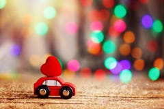 Miniature Car carrying a Red Heart on roof. Holiday concept love royalty free stock photos Miniature Car carrying a Red Heart on roof. Holiday concept love royalty free stock photos