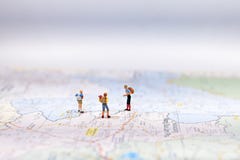 Miniature Group traveler with backpack standing on wold map for travel around the world. Travel Concept, Stock Photography Miniature Group traveler with backpack standing on wold map for travel around the world. Travel Concept, Stock Photography