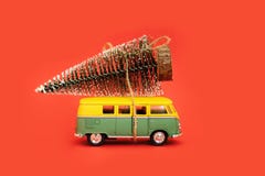 Miniature Hippy Car With Fir Tree On Red Background. Minimal New Yrar 2020 Royalty Free Stock Image Miniature Hippy Car With Fir Tree On Red Background. Minimal New Yrar 2020 Royalty Free Stock Image