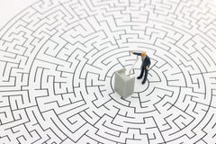 Miniature people: businessman stand with the podium on center of royalty free stock photos Miniature people: businessman stand with the podium on center of royalty free stock photos