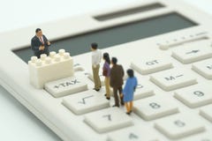 Miniature people Pay queue Annual income TAX for the year on calculator. using as background business concept and finance concep royalty free stock photos Miniature people Pay queue Annual income TAX for the year on calculator. using as background business concept and finance concep royalty free stock photos