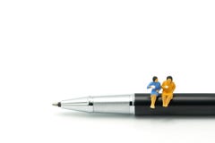 Miniature people Sit on the pens, exchange ideas, discuss problems using as background business concept and finance concept with c royalty free stock photos Miniature people Sit on the pens, exchange ideas, discuss problems using as background business concept and finance concept with c royalty free stock photos