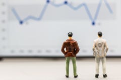 Miniature people : small figures businessmen stand stock images Miniature people : small figures businessmen stand stock images