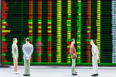 Miniature people : small figures businessmen stand and look at S stock images Miniature people : small figures businessmen stand and look at S stock images