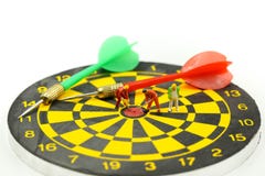 Miniature people : worker digging on the target on dart board, c stock images Miniature people : worker digging on the target on dart board, c stock images