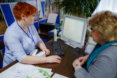 MINSK, BELARUS - FEBRUAR 1, 2018: Doctor taking care of suffering senior patient royalty free stock images MINSK, BELARUS - FEBRUAR 1, 2018: Doctor taking care of suffering senior patient royalty free stock images