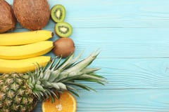 miscela della noce di cocco, della banana, del kiwi, dell'arancia e dell'ananas freschi su fondo di legno blu Vista superiore con immagini stock libere da diritti miscela della noce di cocco, della banana, del kiwi, dell'arancia e dell'ananas freschi su fondo di legno blu Vista superiore con immagini stock libere da diritti