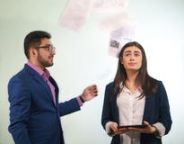 Boss is throwing the papers in a girl office worker, which confused looks up his eyes holding tablet in hands stock photos Boss is throwing the papers in a girl office worker, which confused looks up his eyes holding tablet in hands stock photos