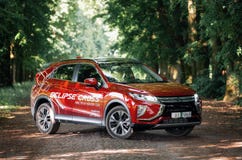 Mitsubishi Eclipse Cross in green forest Stock Photos Mitsubishi Eclipse Cross in green forest Stock Photos