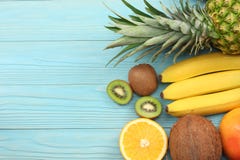 mix of fresh coconut, banana, kiwi fruit, orange and pineapple on blue wooden background. top view with copy space royalty free stock photography mix of fresh coconut, banana, kiwi fruit, orange and pineapple on blue wooden background. top view with copy space royalty free stock photography