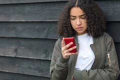 Mixed Race African American Girl Teenager on Cell Phone stock images Mixed Race African American Girl Teenager on Cell Phone stock images