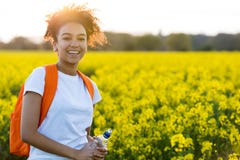 Mixed Race African American Girl Teenager In Yellow Flowers at S stock photography Mixed Race African American Girl Teenager In Yellow Flowers at S stock photography