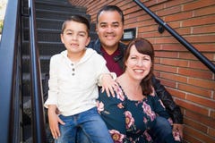 Mixed Race Young Family Portrait in a Stairway royalty free stock image Mixed Race Young Family Portrait in a Stairway royalty free stock image