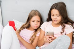 Mobile addicted. Girl play games smartphone online. Pajamas party concept. Happy childhood. Kids surfing internet mobile stock image Mobile addicted. Girl play games smartphone online. Pajamas party concept. Happy childhood. Kids surfing internet mobile stock image