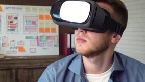 Mobile app developer testing his futuristic app concept using VR headset stock video Mobile app developer testing his futuristic app concept using VR headset stock video