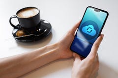 Mobile phone cloud synchronisation process on device screen. Technology concept. stock photo Mobile phone cloud synchronisation process on device screen. Technology concept. stock photo