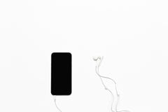 Mobile phone with white earphones isolated royalty free stock photo Mobile phone with white earphones isolated royalty free stock photo