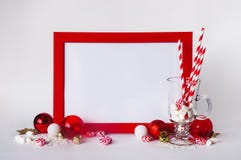 Mock up red frame on a white background with Christmas decorations and candys. Place for text, Invitation, greeting card, paper. royalty free stock photo Mock up red frame on a white background with Christmas decorations and candys. Place for text, Invitation, greeting card, paper. royalty free stock photo
